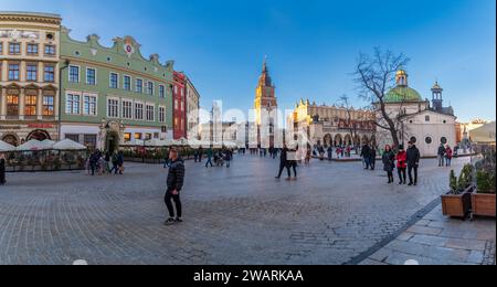 CRACOVIA, POLONIA - 27 DICEMBRE 2023: Pittoresca piazza del mercato vecchia durante il periodo natalizio. La piazza principale è circondata da storiche case cittadine (kamie Foto Stock