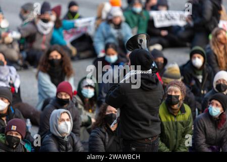 Seattle, Washington, USA. 6 gennaio 2024. Un organizzatore dirige i manifestanti mentre bloccano la i-5 in direzione nord in solidarietà con la Palestina. Le proteste settimanali che chiedono un cessate il fuoco immediato sono aumentate dallo scoppio della guerra tra Israele e gruppi militanti palestinesi guidati da Hamas nella Striscia di Gaza in ottobre. Credito: Paul Christian Gordon/Alamy Live News Foto Stock