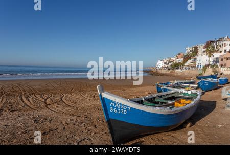 Piccole barche da pesca in legno blu sulla spiaggia di Taghazout, Marocco, Nord Africa Foto Stock