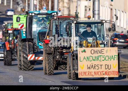 Cottbus, Germania. 8 gennaio 2024. Gli agricoltori guidano i trattori attraverso il centro di Cottbus per una dimostrazione. Protestando contro agricoltori e imprenditori delle aziende di trasporto guidano in una galleria di automobili. Anche altri mestieri, compresi gli artigiani, sostengono le proteste. In risposta ai piani di austerità del governo federale, l'associazione degli agricoltori ha chiesto una settimana di azione con raduni e raduni a partire dall'8 gennaio. Crediti: Frank Hammerschmidt/dpa/Alamy Live News Foto Stock