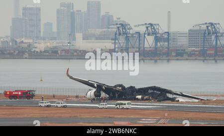 I funzionari indagano su un Airbus A350 della Japan Airlines bruciato dopo una collisione con un aereo della Guardia Costiera giapponese all'aeroporto internazionale di Haneda a Tokyo, in Giappone, il 3 gennaio 2024. Credito: AFLO/Alamy Live News Foto Stock