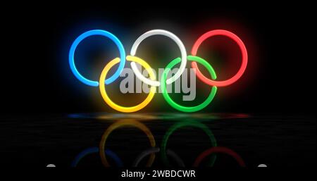 Poznan, Polonia, 7 gennaio 2024: Anelli olimpici simbolo al neon. Lampadine colorate per insegne dei Giochi Olimpici internazionali. Illustrazione 3d del concetto astratto. Foto Stock