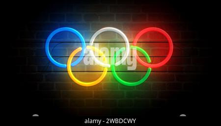 Poznan, Polonia, 7 gennaio 2024: Anelli olimpici simbolo al neon. Lampadine colorate per insegne dei Giochi Olimpici internazionali. Illustrazione 3d del concetto astratto. Foto Stock