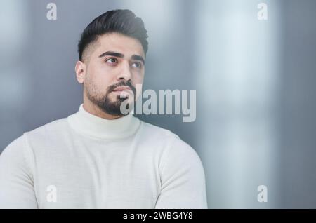 Ritratto di un elegante uomo di mezza età in posa su sfondo grigio Foto Stock
