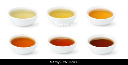Tè cinesi di diversi colori in ciotole bianche, isolati su sfondo bianco Foto Stock