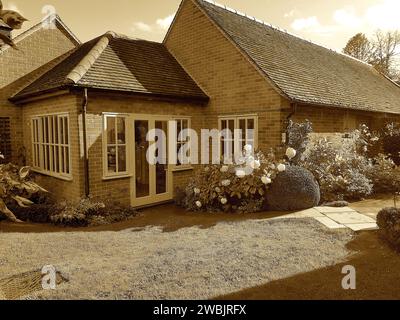 Foto di un vecchio fienile e giardino convertiti in tinta seppia. Foto Stock