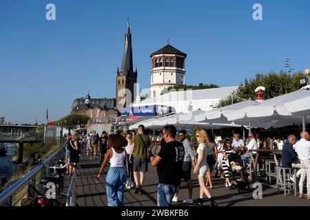 Germania, Renania settentrionale-Vestfalia, Düsseldorf, Rheinuferpromenade, Basilica St Lambertus, torre del castello, caffè di strada, turisti Foto Stock