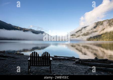 WA23925-00...WASHINGTON - sedia all'aperto sulla riva del lago Crescent in una mattinata nebbiosa al Lake Crescent Lodge. Foto Stock