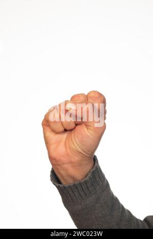 Pugno di donna su sfondo bianco Foto Stock