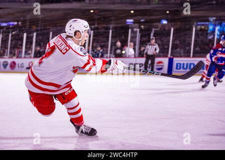 Charlotte, NC, USA. 13 gennaio 2024. Charlotte Checkers Mike Benning (2) spara contro i Rochester Americans nel Queen City Outdoor Classic al Truist Field di Charlotte, North Carolina. (Scott Kinser/CSM). Credito: csm/Alamy Live News Foto Stock