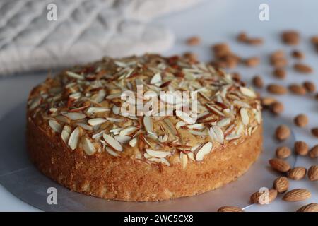 Torta al burro di mandorle. Una deliziosa torta decorata con una spolverata generosa di mandorle tritate, perfetta per il tè. Facile da realizzare e visivamente accattivante Foto Stock