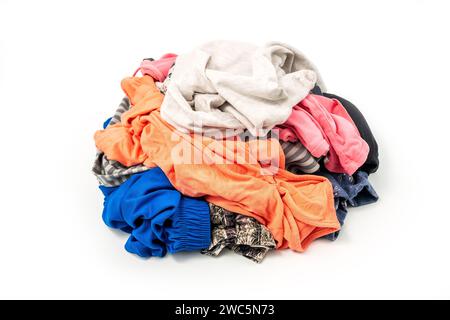 Tessuto pronto per il riciclo, isolato su sfondo bianco. Mucchio di vestiti colorati usati per il riciclaggio Foto Stock