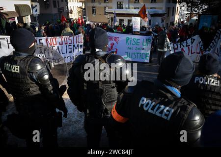 Davos, Svizzera. 14 gennaio 2024. La polizia antisommossa controlla la manifestazione contro il 54° Forum economico Mondiale. Centinaia di manifestanti si sono riuniti per esprimere preoccupazioni sull'agenda del World Economic Forum (WEF) di quest'anno. Il Forum coinvolge i leader politici, commerciali e culturali della società per definire i programmi globali, regionali e industriali, che possono avere un impatto su tutti in tutto il mondo. Credito: SOPA Images Limited/Alamy Live News Foto Stock