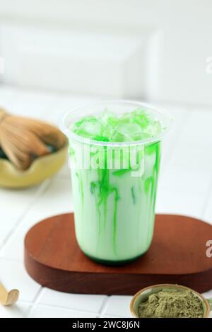 Latte Matcha biologico freddo fatto in casa sano fatto di foglie di tè verde macinato in polvere mescolato con latte o acqua Foto Stock