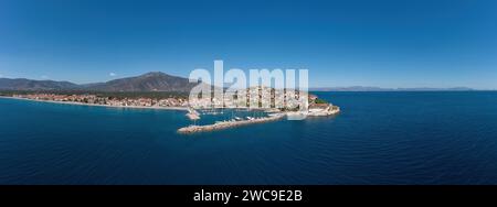 Porto di Paralio Astros, Arcadia, Peloponneso, Grecia. Vista panoramica aerea con drone della città, frangiflutti, barca ormeggiata, acqua di mare, cielo blu. Banner Foto Stock