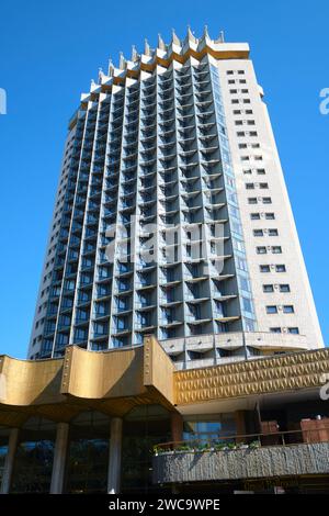 Una vista dell'iconico Hotel Kazakhstan a 26 piani con tettoia frontale dorata, aperto nel 1977. È un esempio di architettura socialista sovietica, modernista. Foto Stock