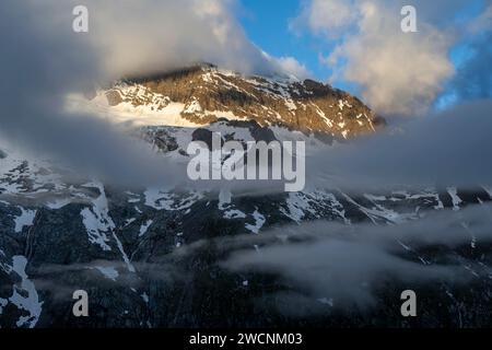 Paesaggio montano nuvoloso con una luce intensa del mattino, vetta Griesferner con neve, Berliner Hoehenweg, Zillertal, Tirolo, Austria Foto Stock