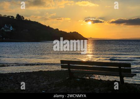 Panchina sulla spiaggia di le caro poco di fronte al tramonto, vista sulla Presqu'ile de Crozon, sulla penisola di Plougastel-Daoulas, sul dipartimento Finistere Penn-ar-Bed Foto Stock