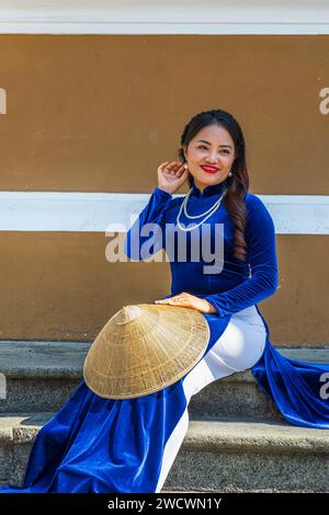 Vietnam, ho chi Minh City (Saigon), giovane donna che indossa il áo dài, abito tradizionale vietnamita Foto Stock