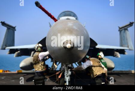 I marinai eseguono i controlli finali su un F/A-18E Super Hornet a bordo della USS Nimitz. Foto Stock