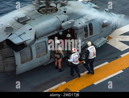 I marinai scortano un residente salvato della Guadalupe francese sul ponte di volo della USS Wasp. Foto Stock