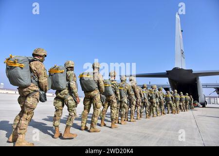 I paracadutisti dell'esercito americano si preparano a salire a bordo di un aereo C-130 Hercules dell'aeronautica statunitense. Foto Stock