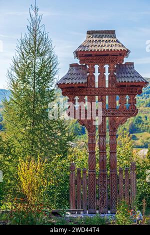 Croce decorativa in legno intagliata con motivi tradizionali rumeni, specifica per l'area Maramures, il monastero di Barsana, Romania. Foto Stock