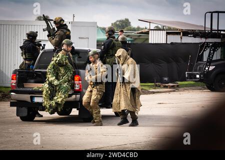 Forze speciali SWAT polizia e unità tattiche in ostaggi di salvataggio uniformi in uno scenario di addestramento al NATO Days Airshow 2022. Soldati con pistole difendono. Foto Stock