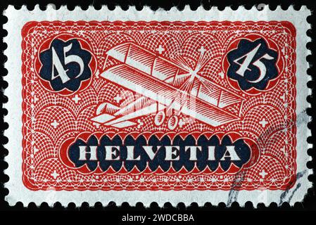 Vecchio biplano su francobollo svizzero d'epoca Foto Stock