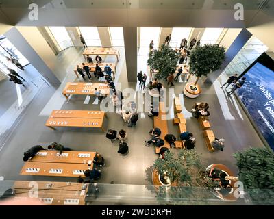 Barselona, Spagna - 13.01.2024: Vista dall'alto dello spazio al piano terra dell'Apple Store, dove le persone cercano di scegliere nuovi prodotti Apple. Foto Stock