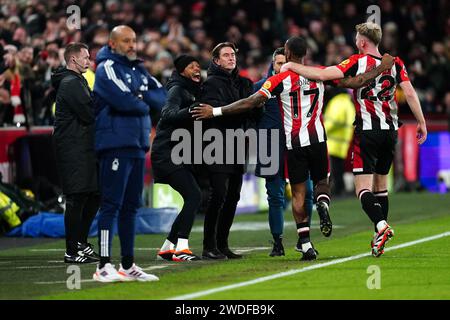 Ivan Toney di Brentford (secondo a destra) celebra il primo gol della loro squadra della partita con il manager Thomas Frank (centro) come il manager del Nottingham Forest Nuno Espirito Santo (secondo a sinistra) sembra frustrato durante la partita di Premier League al Gtech Community Stadium di Londra. Data immagine: Sabato 20 gennaio 2024. Foto Stock