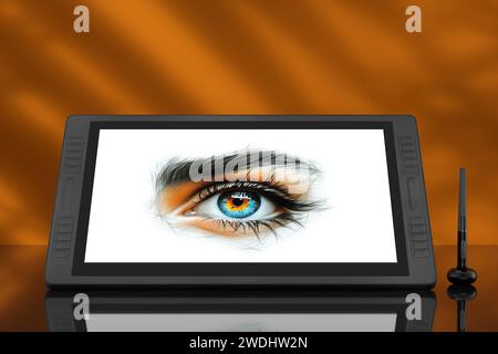 Monitor tablet per disegno grafico digitale di grandi dimensioni con penna e disegno astratto di un occhio femmina dai colori vivaci su sfondo arancione. Rendering 3d. Foto Stock