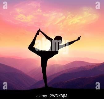 Una donna pratica yoga su uno sfondo di montagne e cielo. Concetto di stile di vita sano. Foto Stock