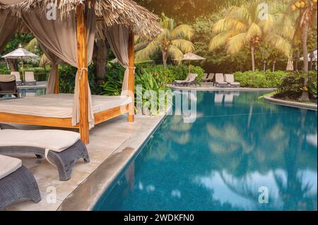 Piscina esterna in un resort tropicale in una luminosa giornata di sole Foto Stock