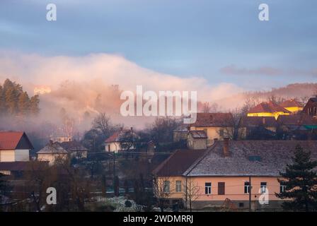 Vista su un villaggio annidato tra le maestose cime delle montagne Foto Stock