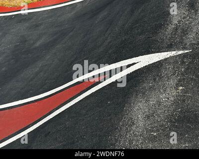 Vibrazioni della pista: Linee bianche e accenti rossi adornano l'asfalto, definendo il flusso energetico delle corse dinamiche su questo emozionante circuito. Foto Stock