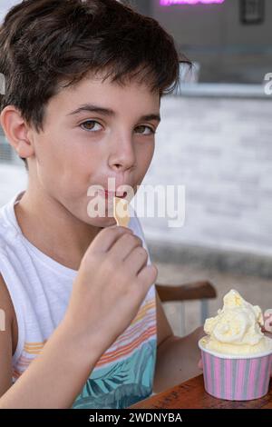 Bambino brasiliano di 10 anni che mangia un gelato in un pomeriggio di sole 7. Foto Stock