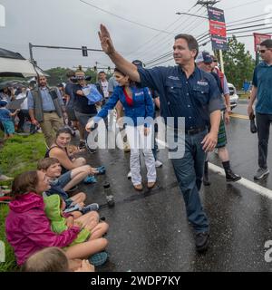 Merrimack, New Hampshire USA 4 luglio 2023 Governatore della Florida e candidato presidenziale repubblicano Ron DeSantis in marcia a Merrimack, NH 4 luglio sfilata, sotto la pioggia, con sua moglie Casey DeSantis e sua figlia Madison DeSantis, 5 anni. Desantis sospese la sua campagna presidenziale il 21 gennaio 2024, due giorni prima delle primarie repubblicane del New Hampshire. (Rick Friedman) Foto Stock