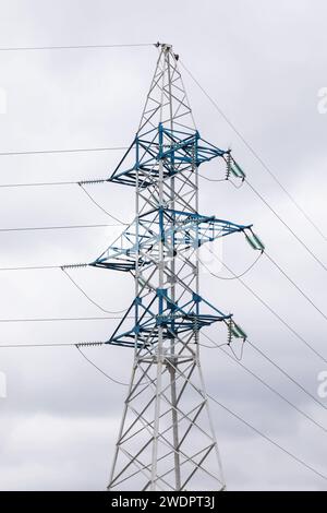 Supporto metallico di una linea di alimentazione ad alta tensione contro un cielo nuvoloso Foto Stock