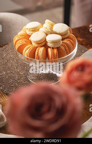 Macaron color pastello in un'elegante ciotola di vetro su un tavolo dolce Foto Stock