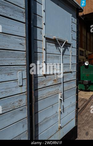 Una parete grigia di una vecchia struttura in legno alla stazione ferroviaria Foto Stock