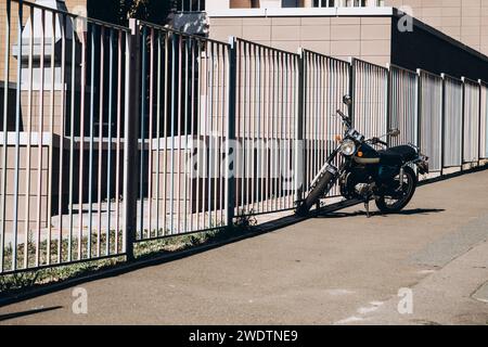 motocicletta vicino a una lunga recinzione. Foto di alta qualità Foto Stock