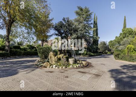 Una fontana nel gazebo di una passeggiata pavimentata all'interno di un ampio albergo con una casa per famiglie singola Foto Stock