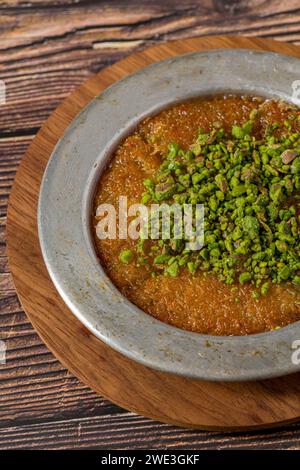 Dessert turco tradizionale kunefe al pistacchio su un tavolo di legno Foto Stock