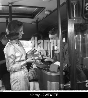 Mazetti Chocolate. Una giovane donna su un autobus invita l'autista dell'autobus a degustare la sua torta al cioccolato fondente e in cambio viene vista ottenere un biglietto dell'autobus. 1962. Kristoffersson rif. CZ55-8 Foto Stock