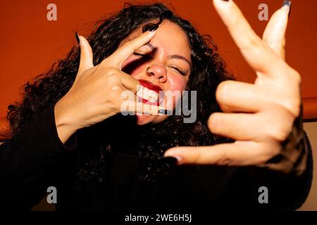 Giovane donna con un atteggiamento figo che fa firmare Shaka Foto Stock