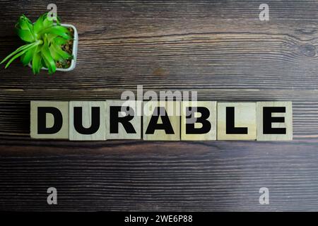 Concetto di cubi di legno con la parola durevole su sfondo di legno. Foto Stock