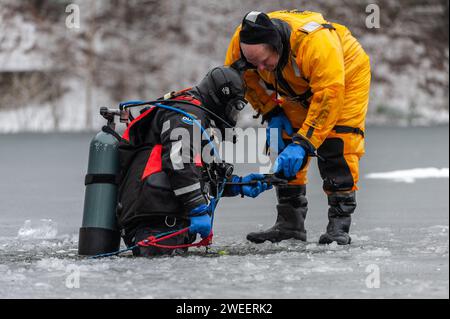 Vigili del fuoco e polizia con la squadra subacquea del Massachusetts District 14, che conduce un addestramento di soccorso su ghiaccio a White Pond a Concord. Foto Stock