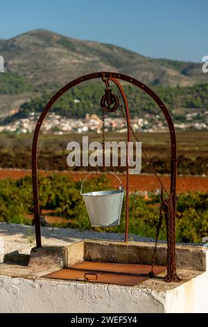 Vecchio pozzo e secchio nel villaggio di Lliber, Alicante, Costa Blanca, Spagna - foto di magazzino Foto Stock