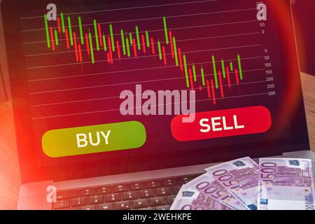25 gennaio 2024: Computer portatile con grafico delle scorte sul segnale rosso di vendita accanto al segnale verde di acquisto. Immagine simbolo per il commercio e le perdite di azioni e ETF FOTOMONTAGE *** laptop computer mit Aktien Chart auf rotem Verkaufen Signal neben grünem Kaufen Signal. Symbolbild für Handel und Verluste von Aktien und ETF FOTOMONTAGE Foto Stock